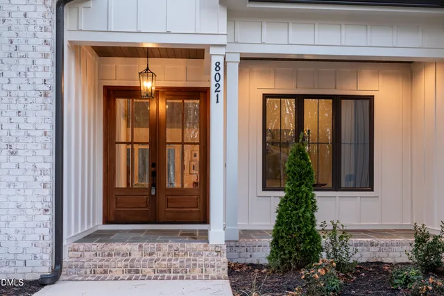 a large white kitchen with a large island oven a stove and a wooden floors