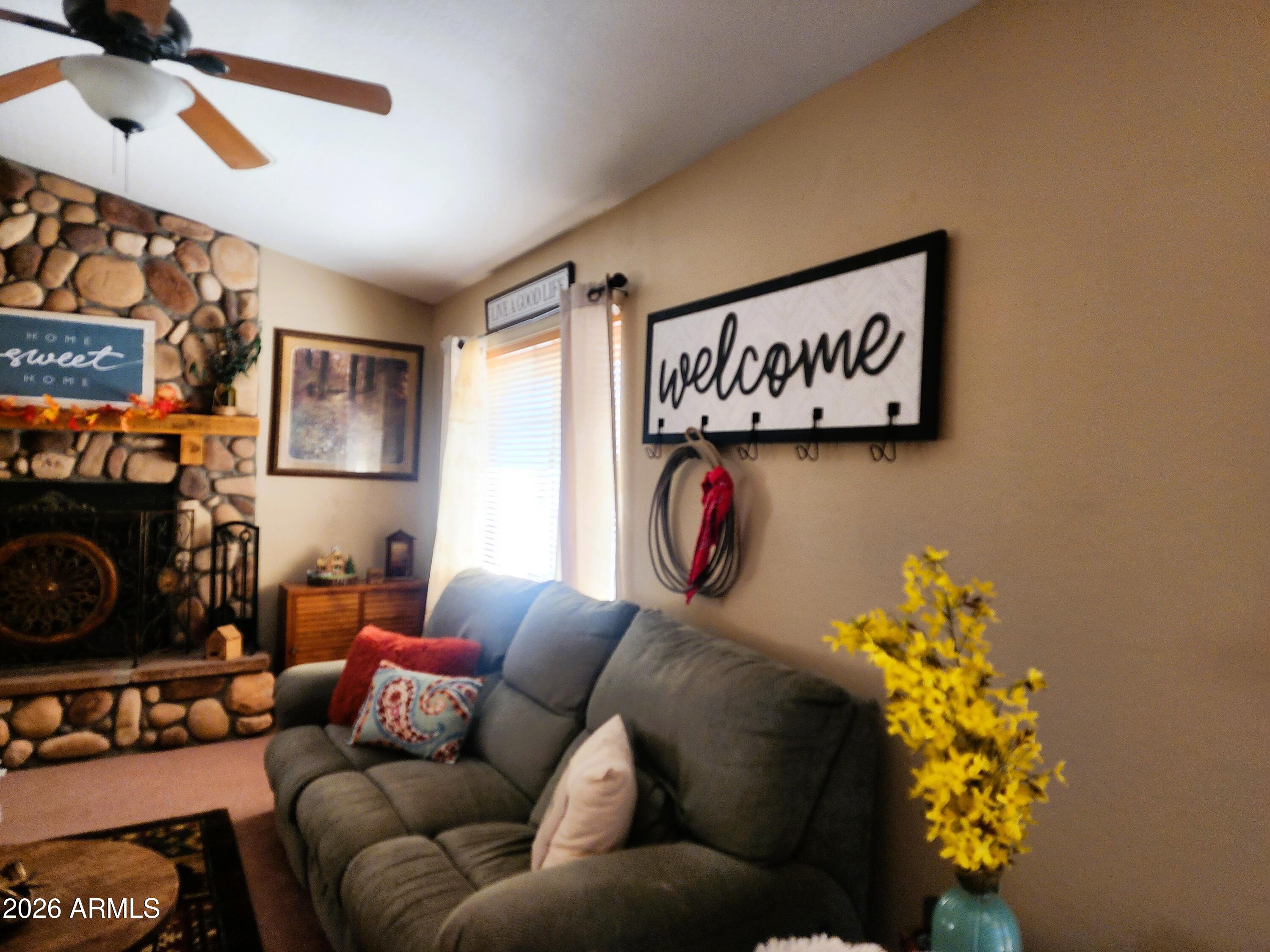2086 Pinewood Drive Overgaard, AZ 85933 - Photo 12 of 33 a living room with furniture and a fireplace