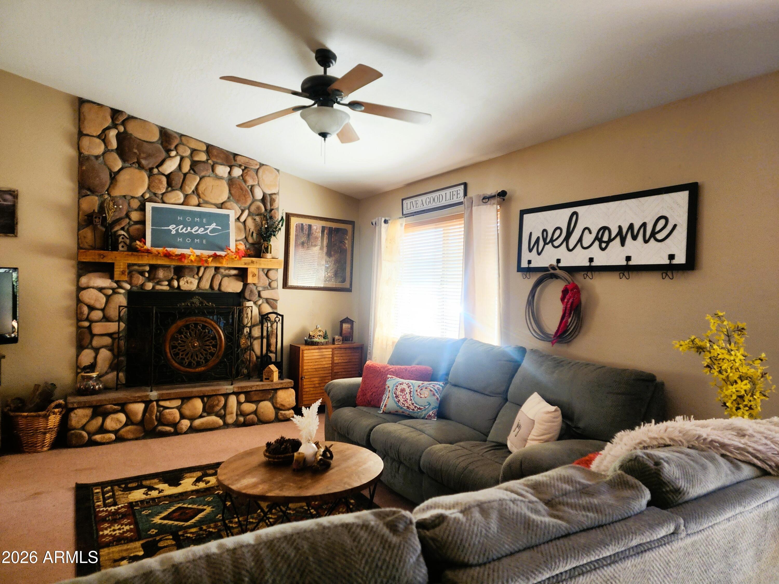 2086 Pinewood Drive Overgaard, AZ 85933 - Photo 13 of 33 a living room with furniture and a fireplace