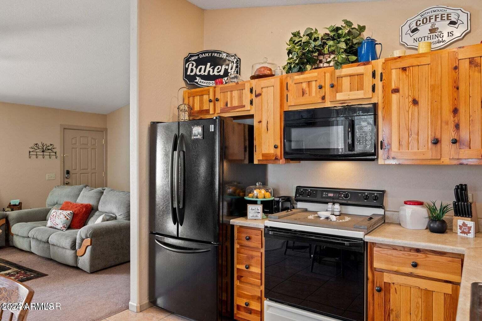 2086 Pinewood Drive Overgaard, AZ 85933 - Photo 17 of 33 a kitchen with stainless steel appliances granite countertop a refrigerator stove and microwave