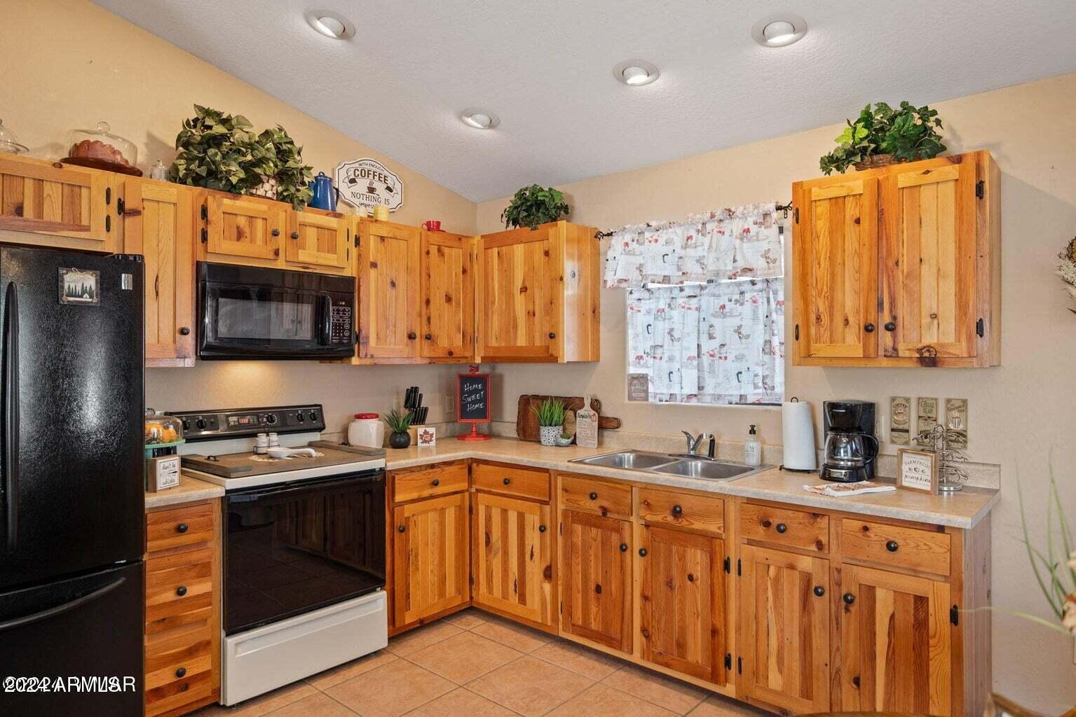 2086 Pinewood Drive Overgaard, AZ 85933 - Photo 18 of 33 a kitchen with stainless steel appliances a sink a stove a microwave a refrigerator and cabinets