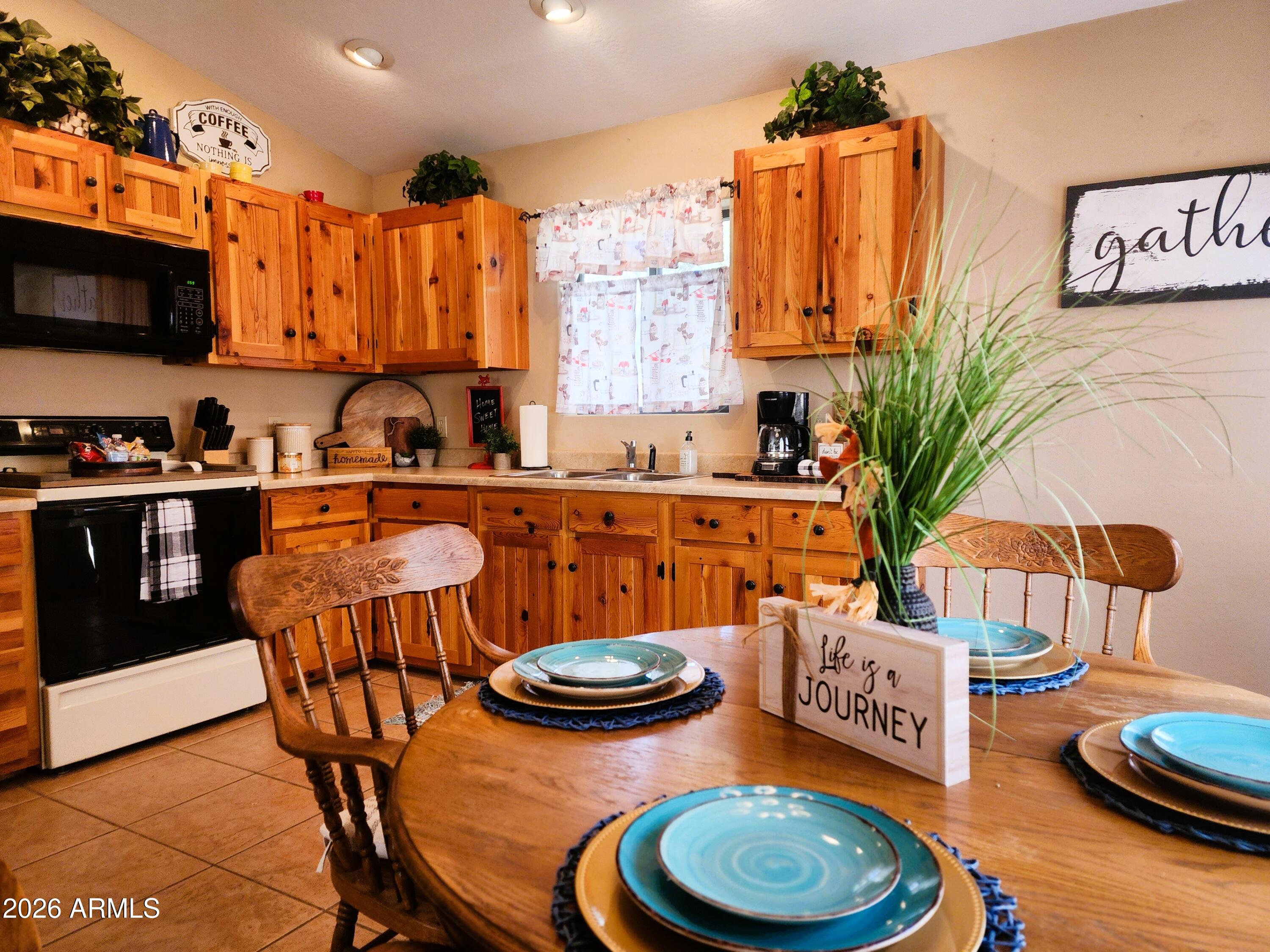 2086 Pinewood Drive Overgaard, AZ 85933 - Photo 19 of 33 a kitchen with stainless steel appliances a dining table and chairs