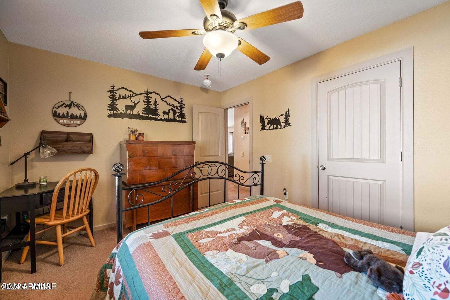 2086 Pinewood Drive Overgaard, AZ 85933 - Photo 27 of 33 a bedroom with a bed and a chandelier