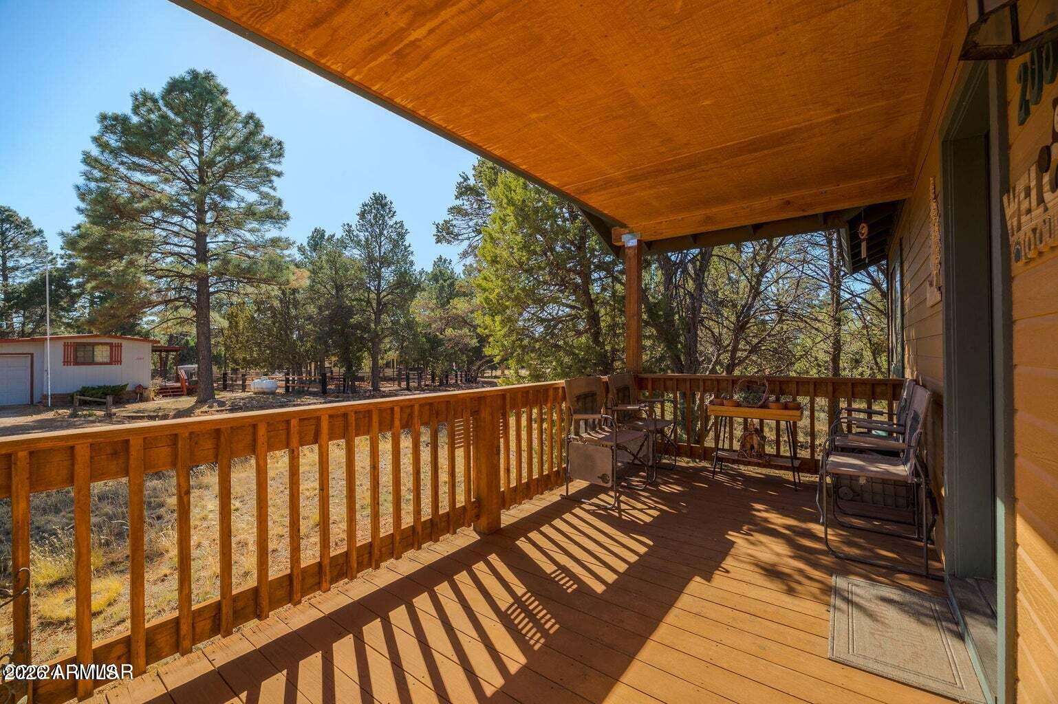 2086 Pinewood Drive Overgaard, AZ 85933 - Photo 6 of 33 a balcony with wooden floor and wooden fence