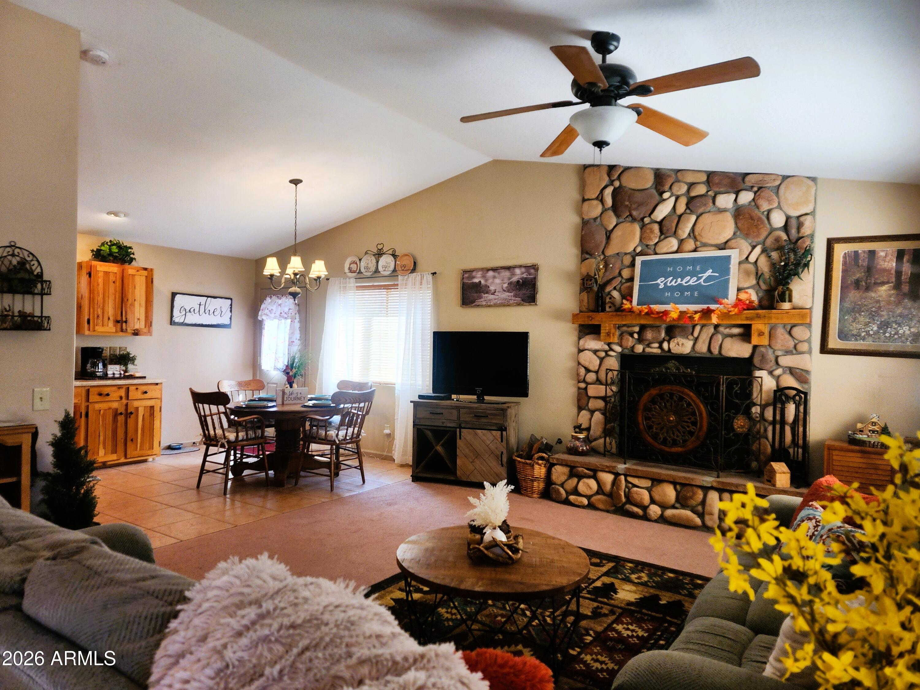2086 Pinewood Drive Overgaard, AZ 85933 - Photo 9 of 33 a living room with furniture a flat screen tv and a fireplace