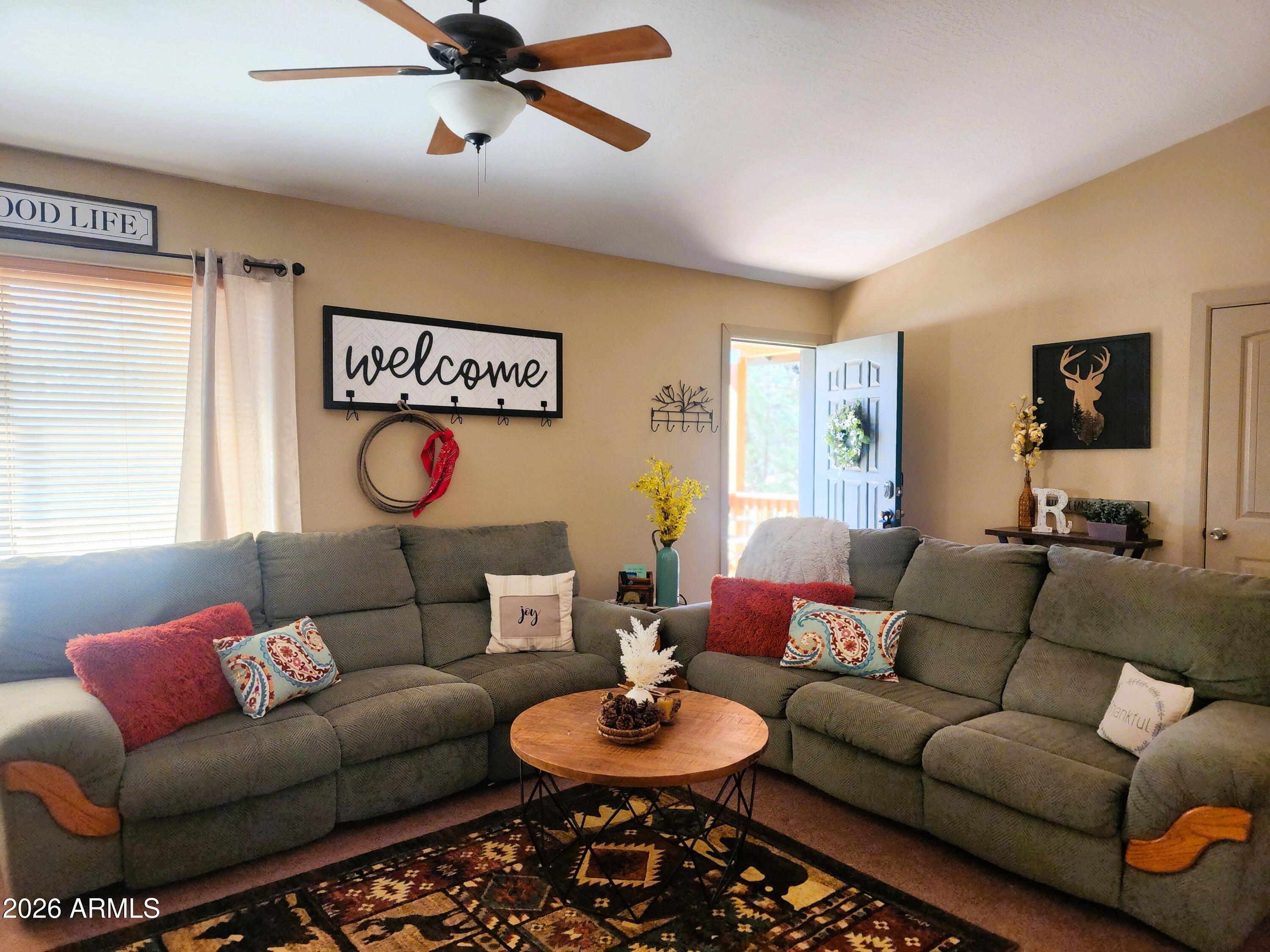 2086 Pinewood Drive Overgaard, AZ 85933 - Photo 10 of 33 a living room with furniture a rug and a window