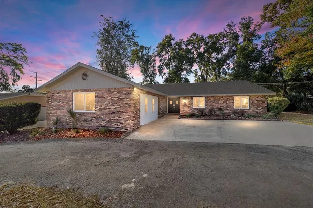 a large kitchen with stainless steel appliances granite countertop a lot of counter space and wooden floor