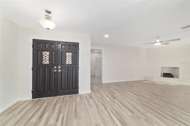 a kitchen with stainless steel appliances a white table chairs and a refrigerator