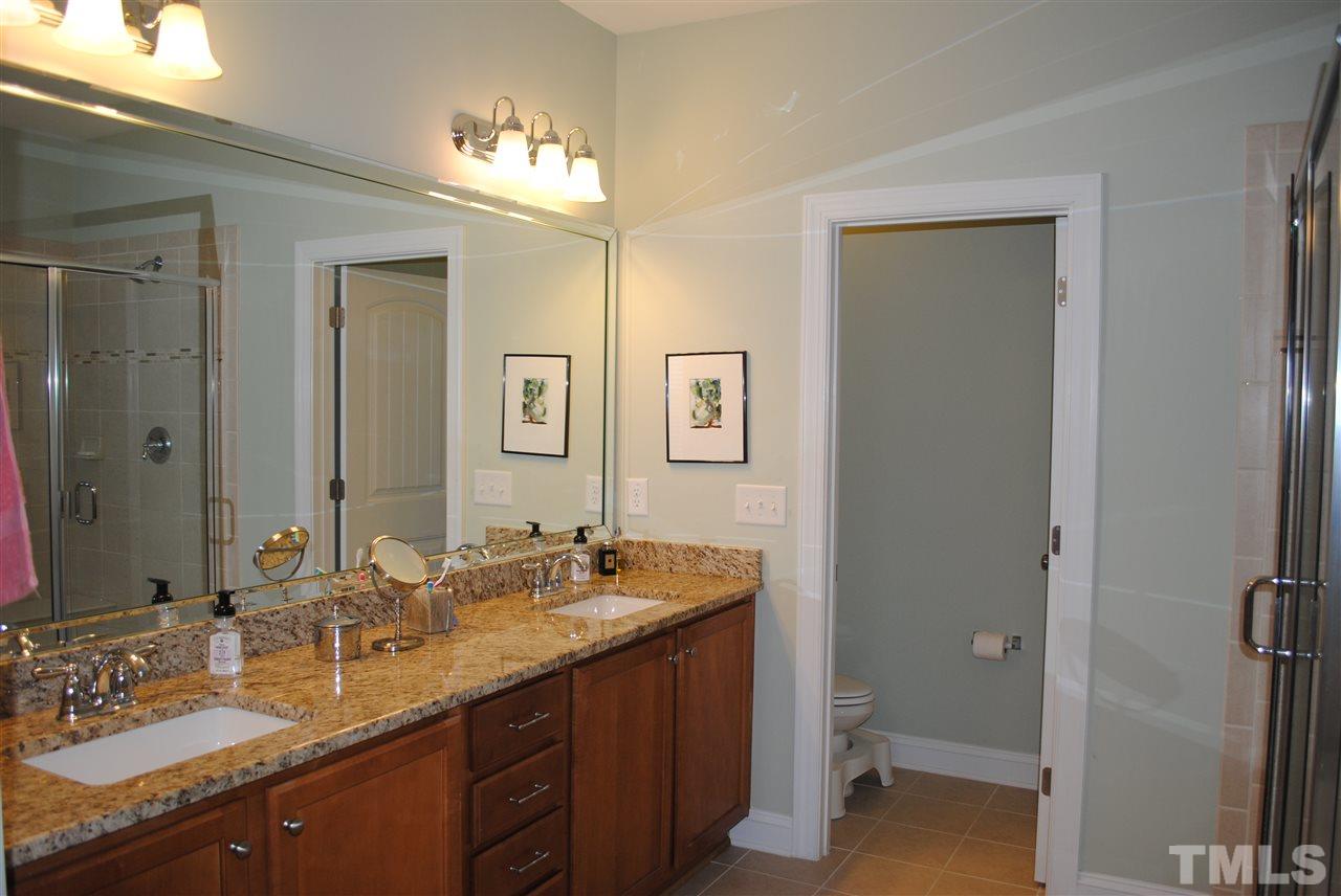 2352 Noble Road Raleigh, NC 27608 - Photo 13 of 24 a bathroom with a granite countertop sink double vanity and a mirror