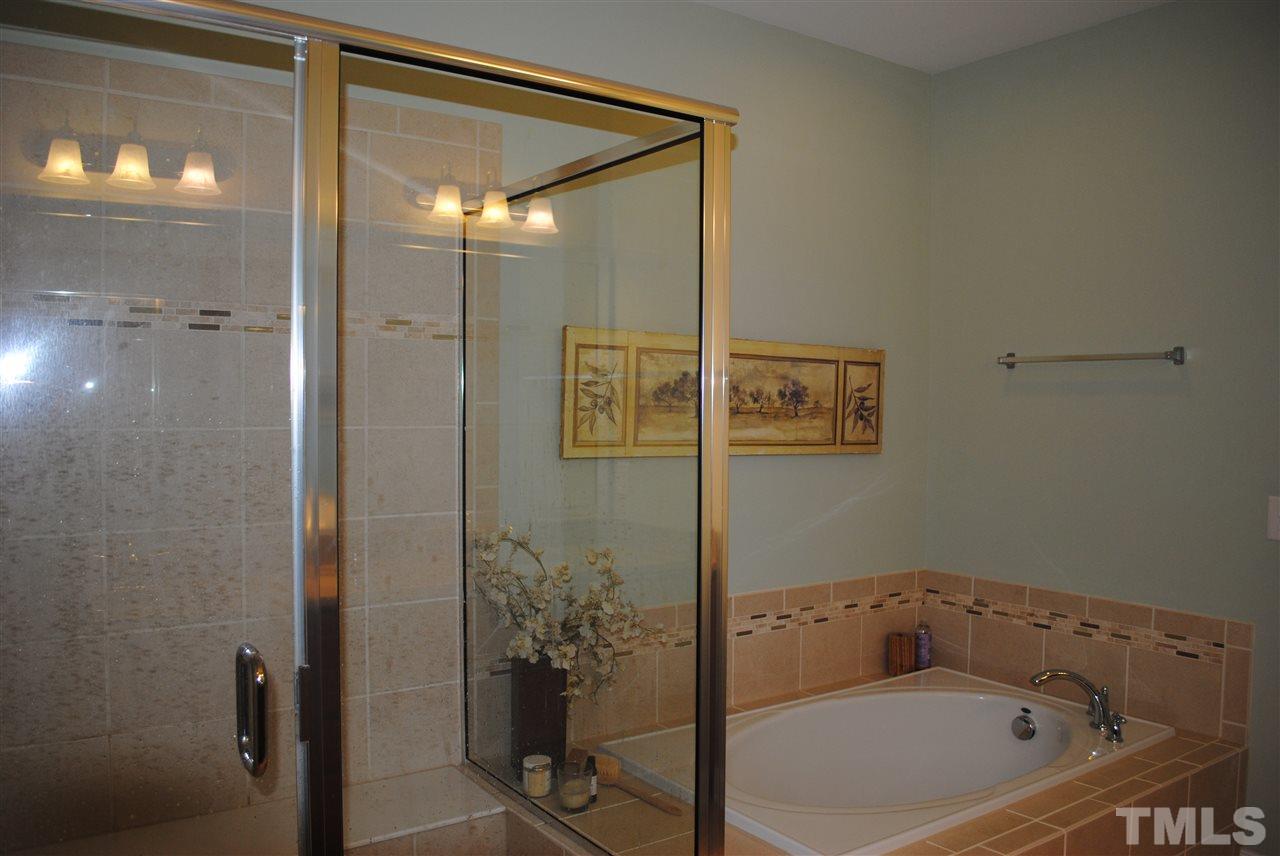 2352 Noble Road Raleigh, NC 27608 - Photo 14 of 24 a bathroom with a bathtub and shower