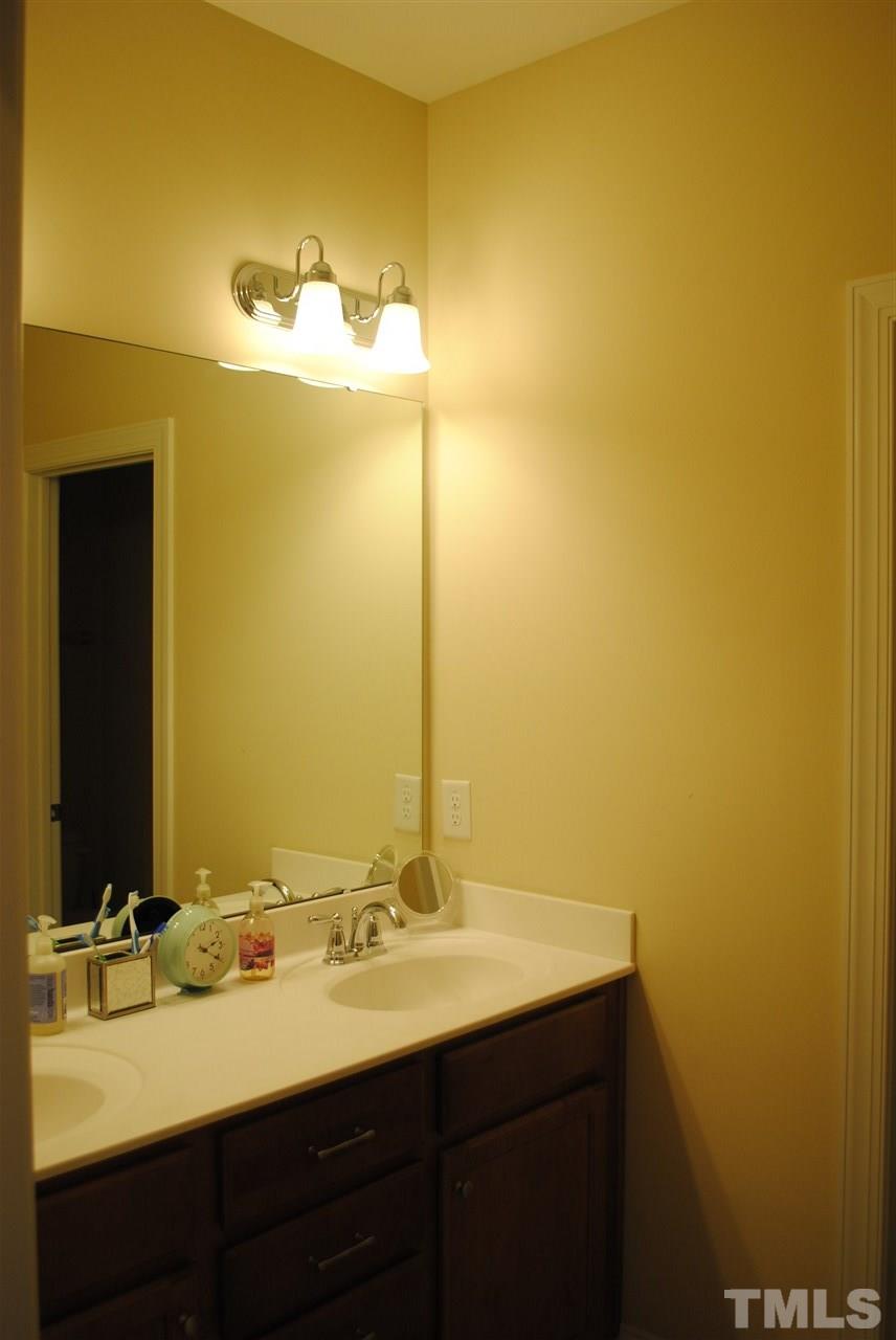 2352 Noble Road Raleigh, NC 27608 - Photo 17 of 24 a bathroom with a sink and a mirror