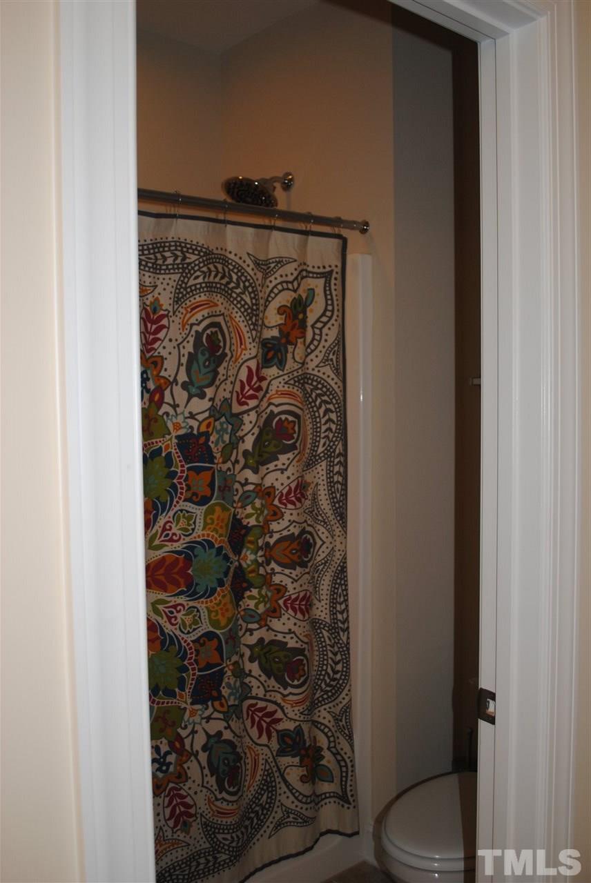 2352 Noble Road Raleigh, NC 27608 - Photo 18 of 24 a bathroom with a toilet and shower curtain