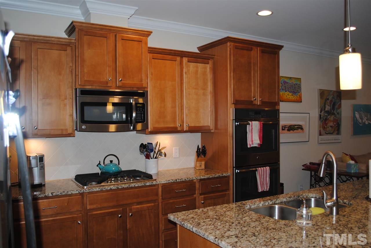 2352 Noble Road Raleigh, NC 27608 - Photo 4 of 24 a kitchen with stainless steel appliances granite countertop a refrigerator stove and sink