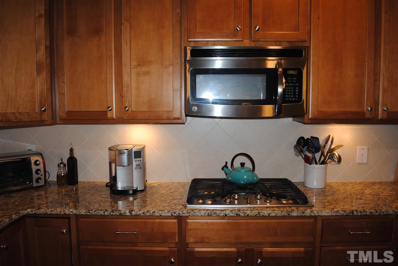 2352 Noble Road Raleigh, NC 27608 - Photo 5 of 24 a kitchen with a stove and cabinets