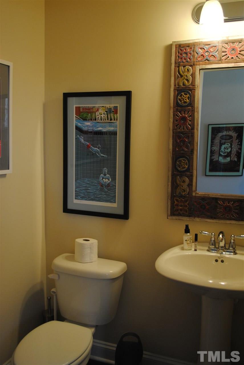 2352 Noble Road Raleigh, NC 27608 - Photo 8 of 24 a bathroom with a toilet a sink and mirror