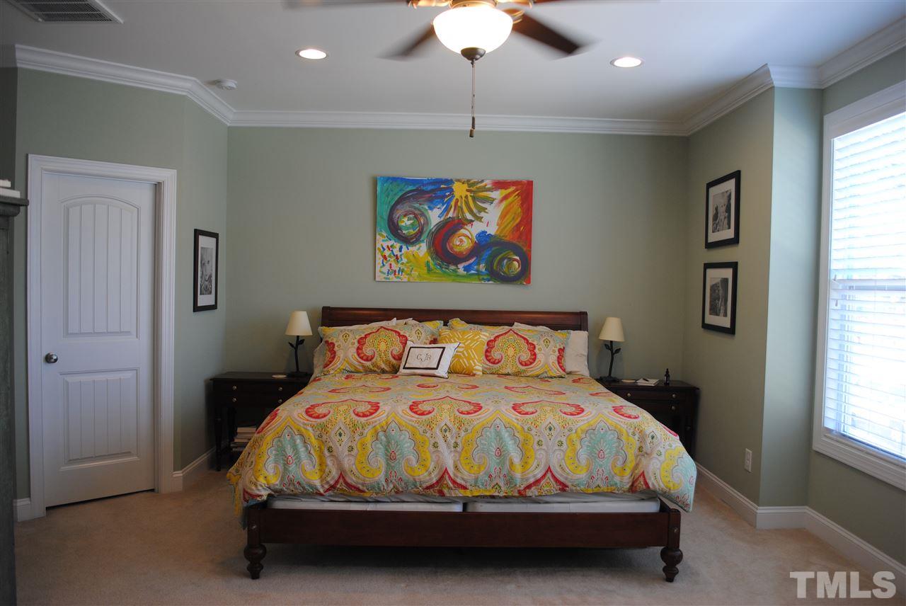 2352 Noble Road Raleigh, NC 27608 - Photo 10 of 24 a bedroom with a bed and a painting on the wall