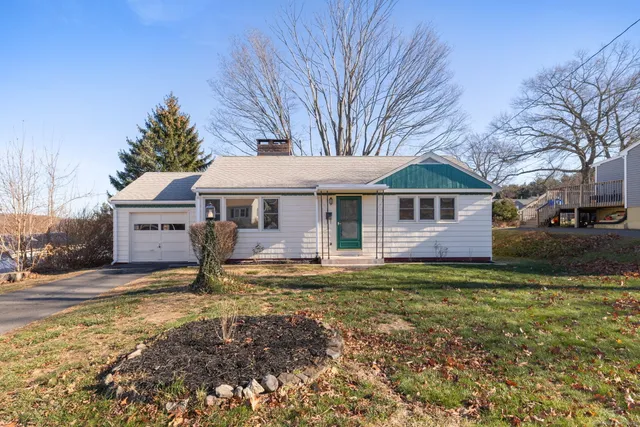a front view of a house with a garden