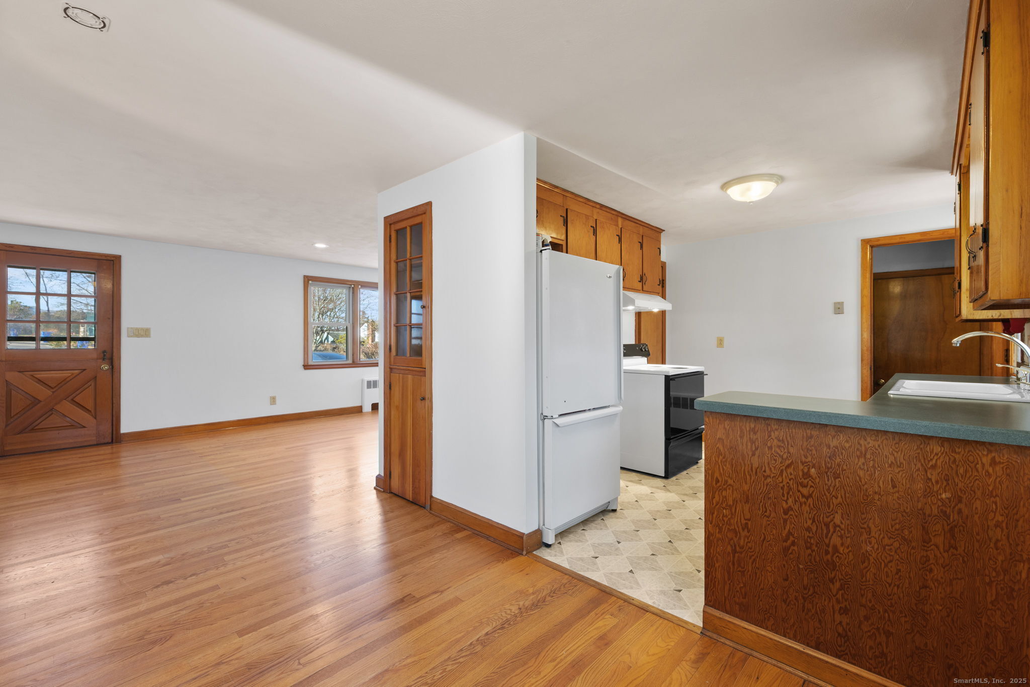 95 Tuttle Street Bristol, CT 06010 - Photo 11 of 28 a kitchen with a refrigerator sink and wooden floor