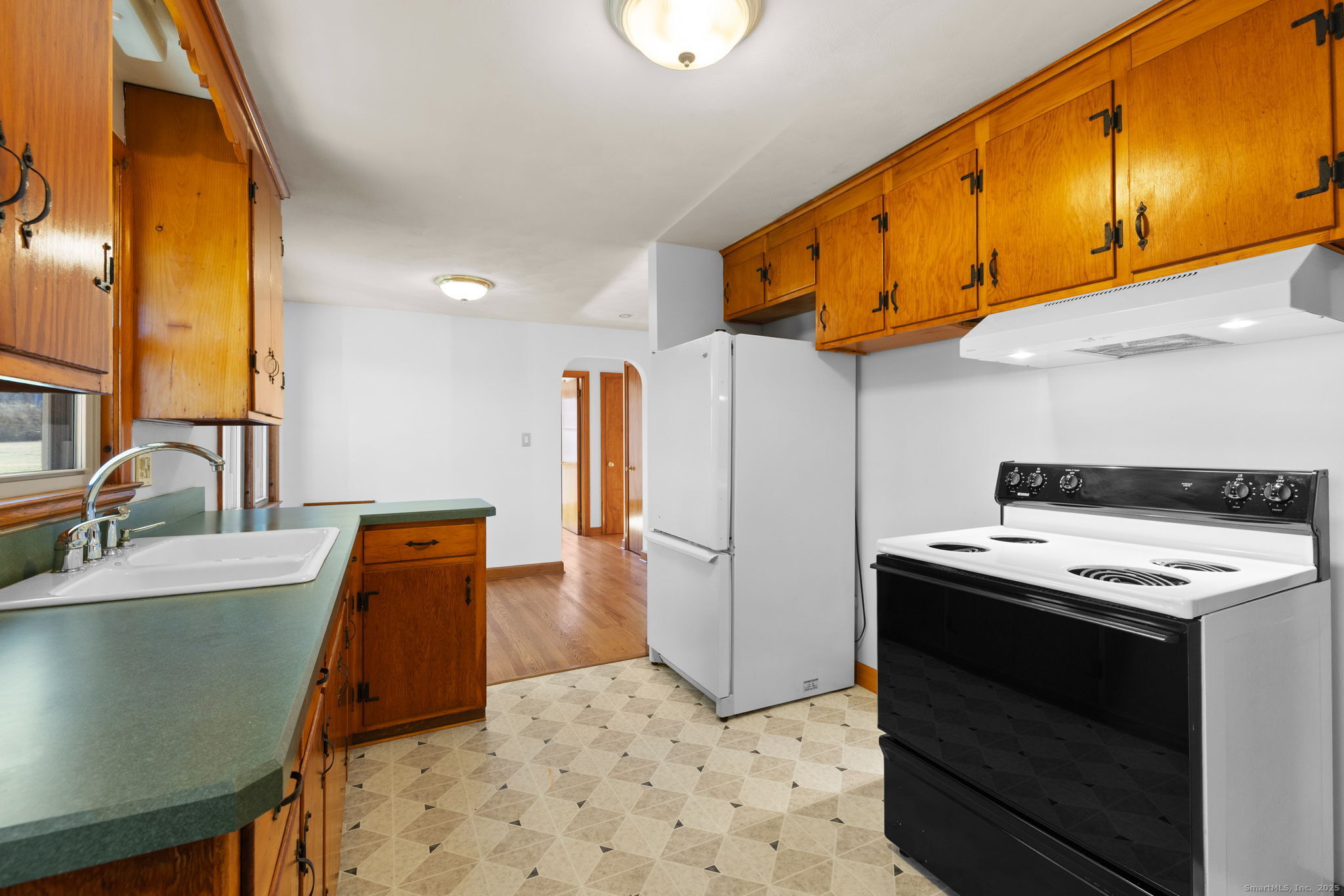 95 Tuttle Street Bristol, CT 06010 - Photo 14 of 28 a kitchen with stainless steel appliances granite countertop a sink a stove and a refrigerator