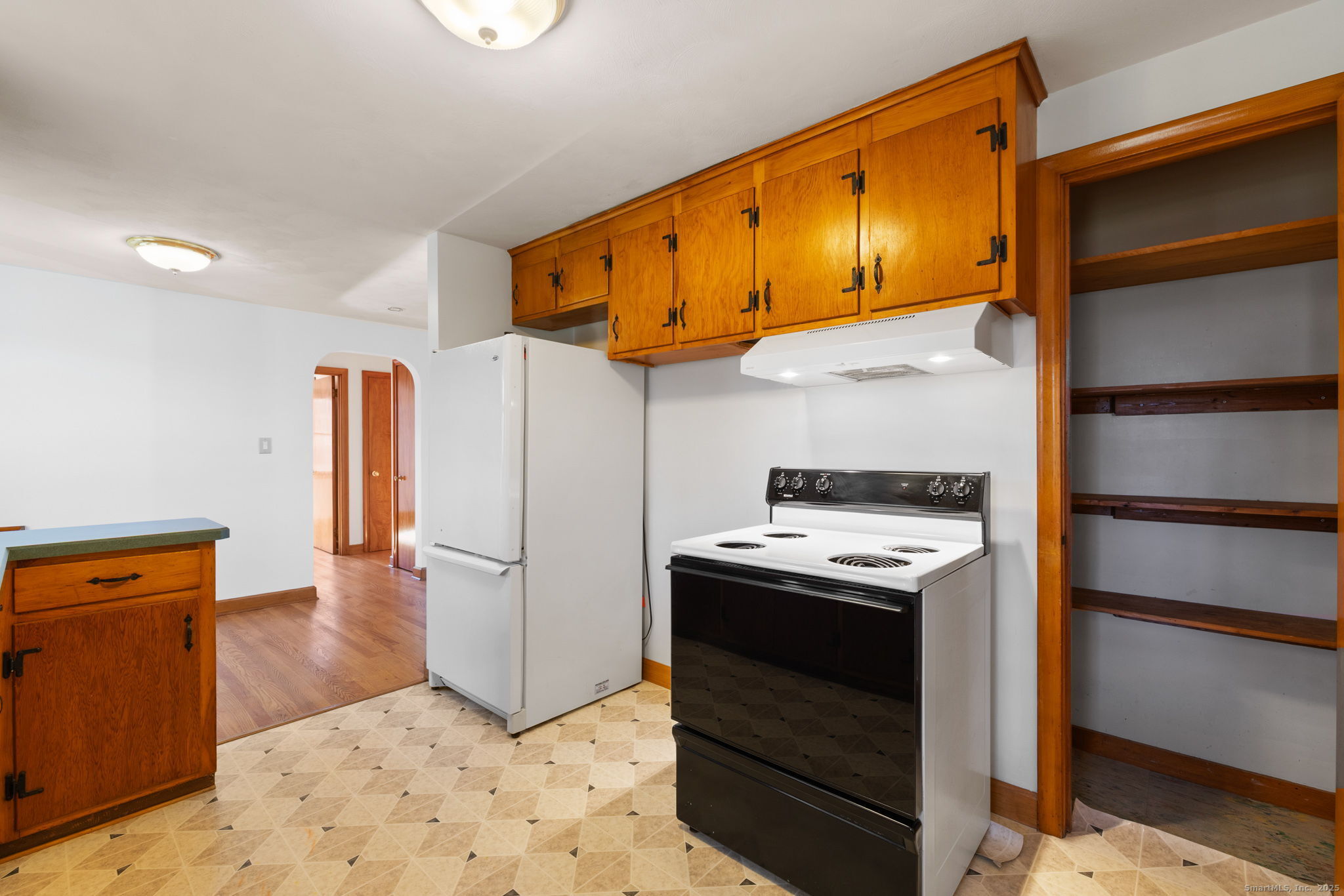 95 Tuttle Street Bristol, CT 06010 - Photo 15 of 28 a kitchen with stainless steel appliances granite countertop a refrigerator a stove and a sink with wooden floors