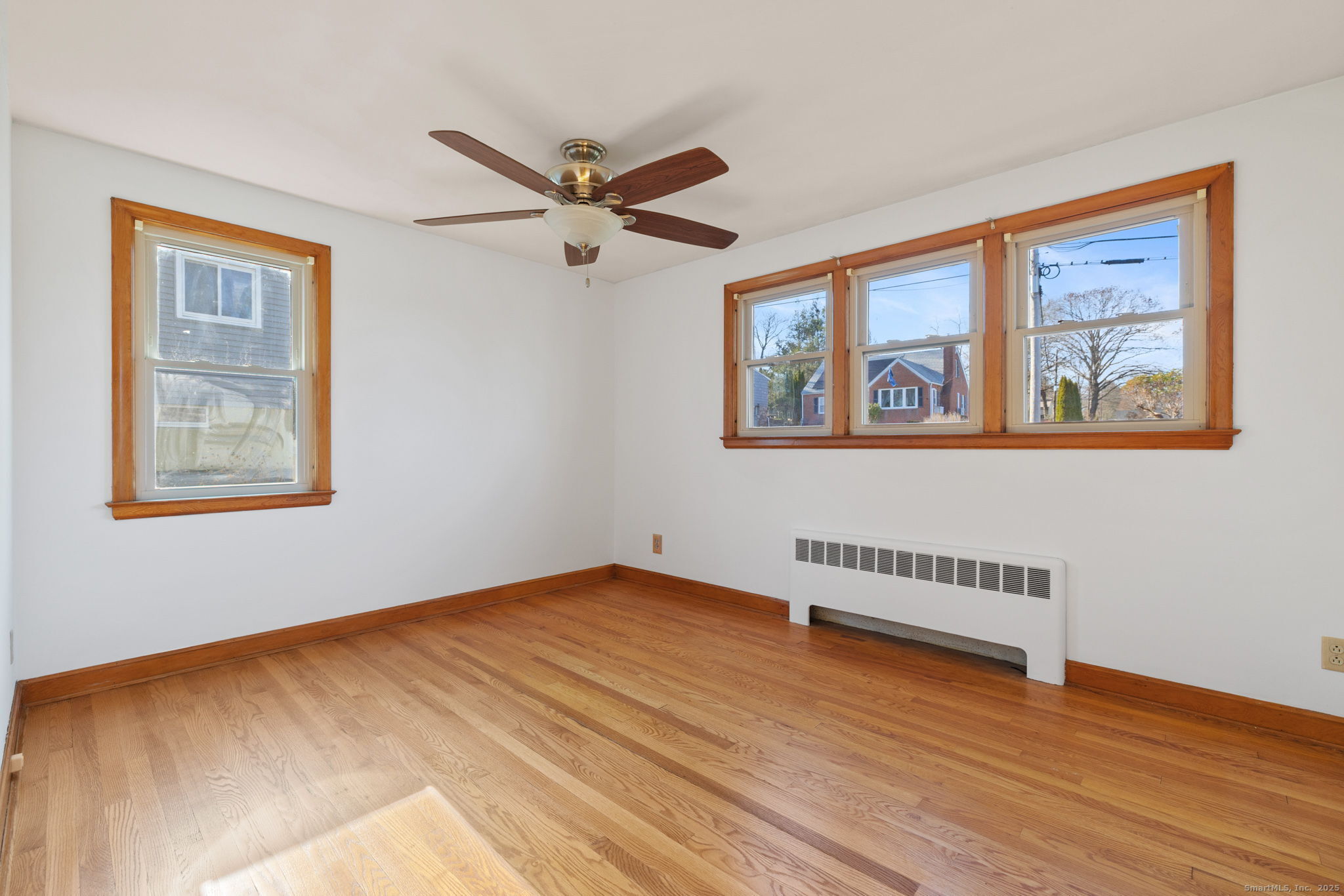 95 Tuttle Street Bristol, CT 06010 - Photo 16 of 28 a view of an empty room with wooden floor and a window