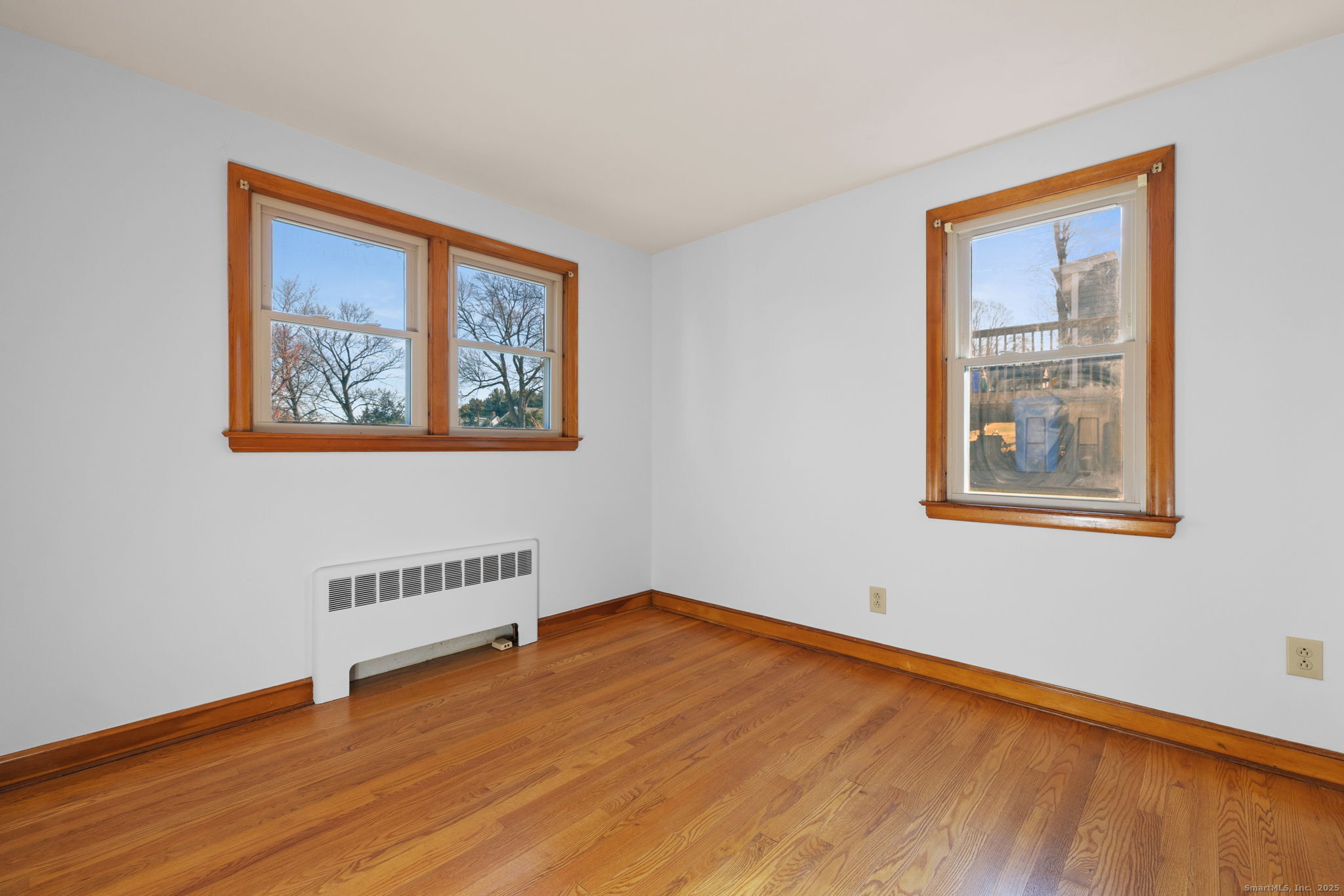 95 Tuttle Street Bristol, CT 06010 - Photo 18 of 28 a view of an empty room with wooden floor and a window