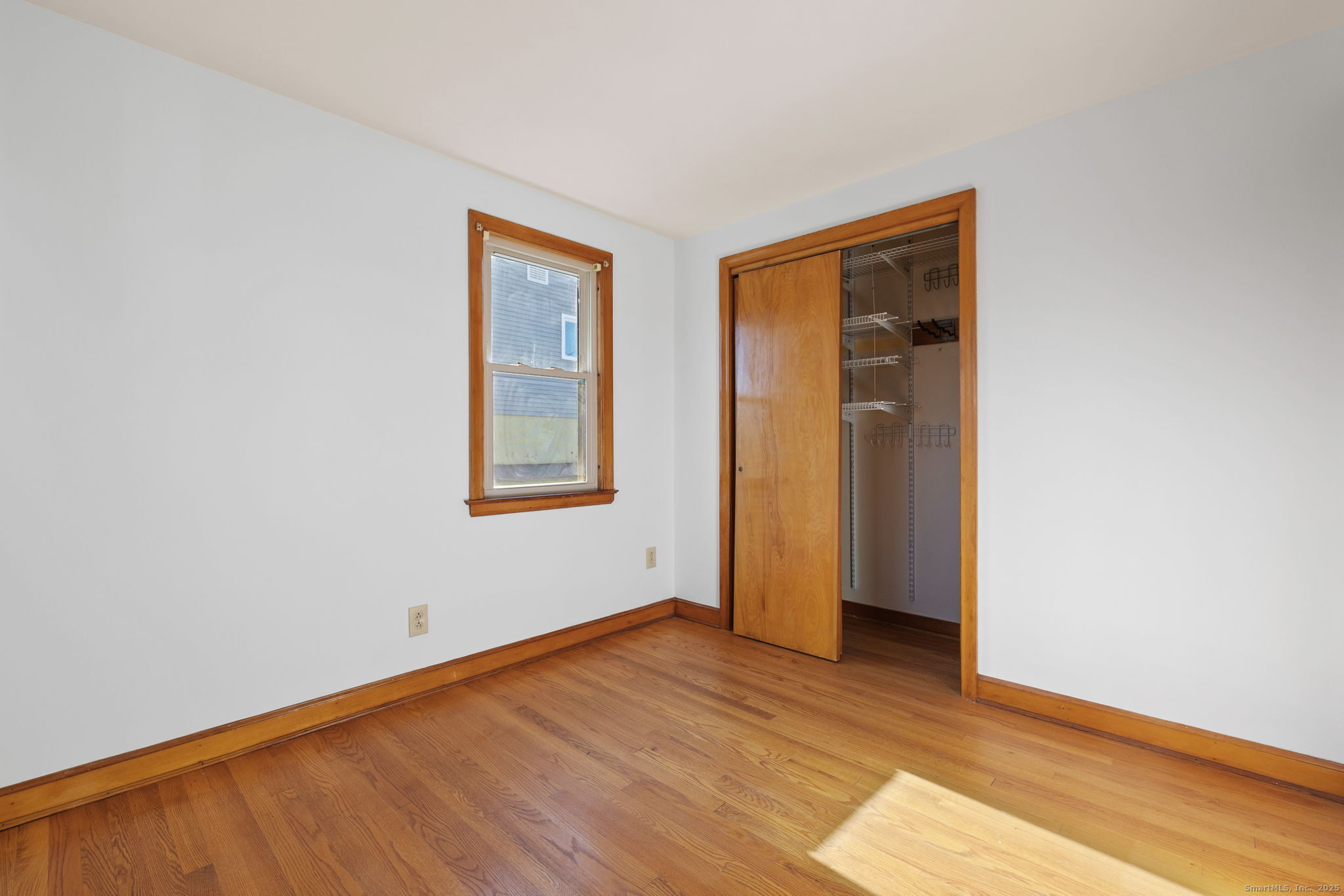 95 Tuttle Street Bristol, CT 06010 - Photo 19 of 28 an empty room with wooden floor and windows