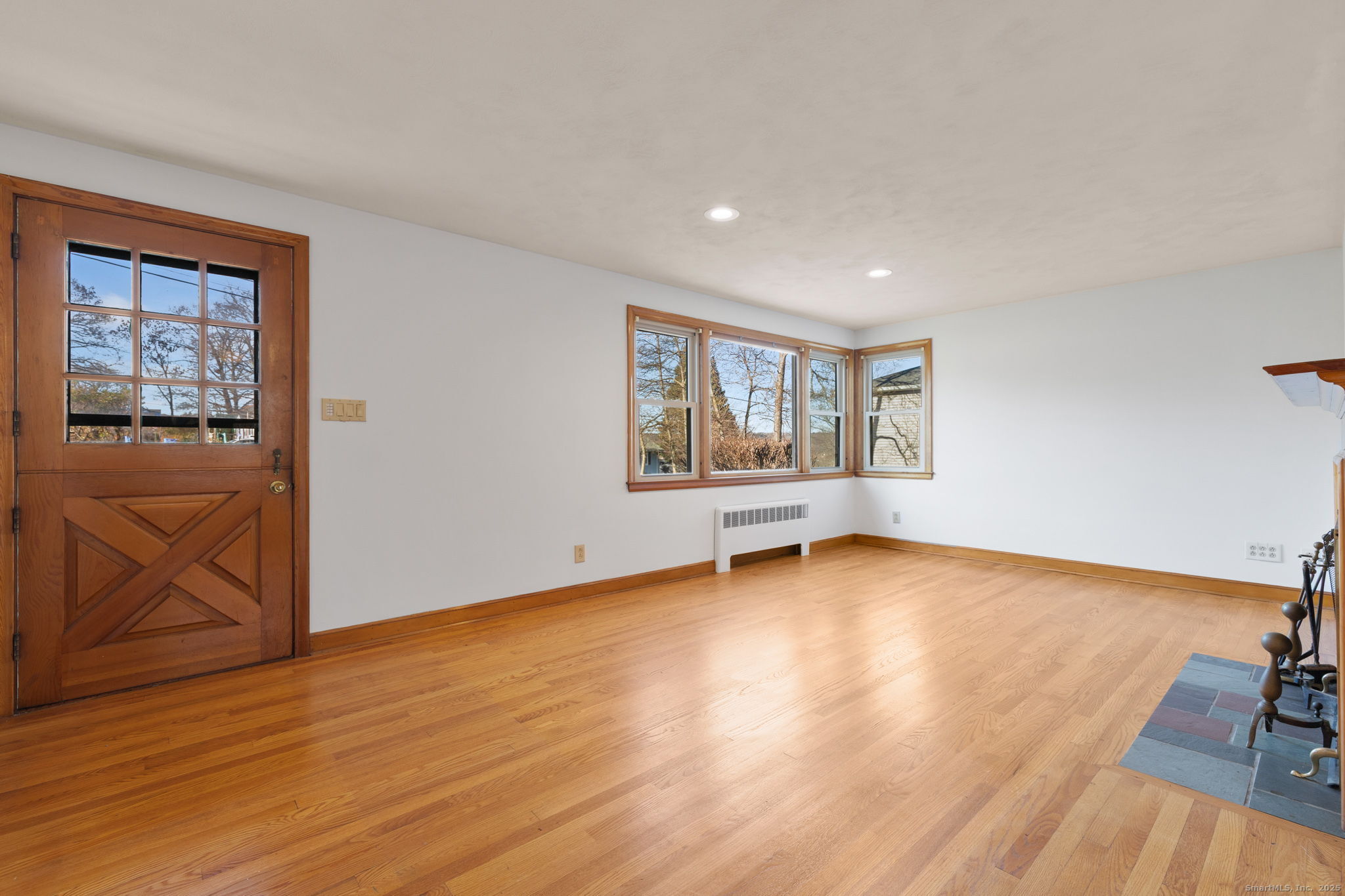95 Tuttle Street Bristol, CT 06010 - Photo 4 of 28 a view of an empty room with a window and wooden floor