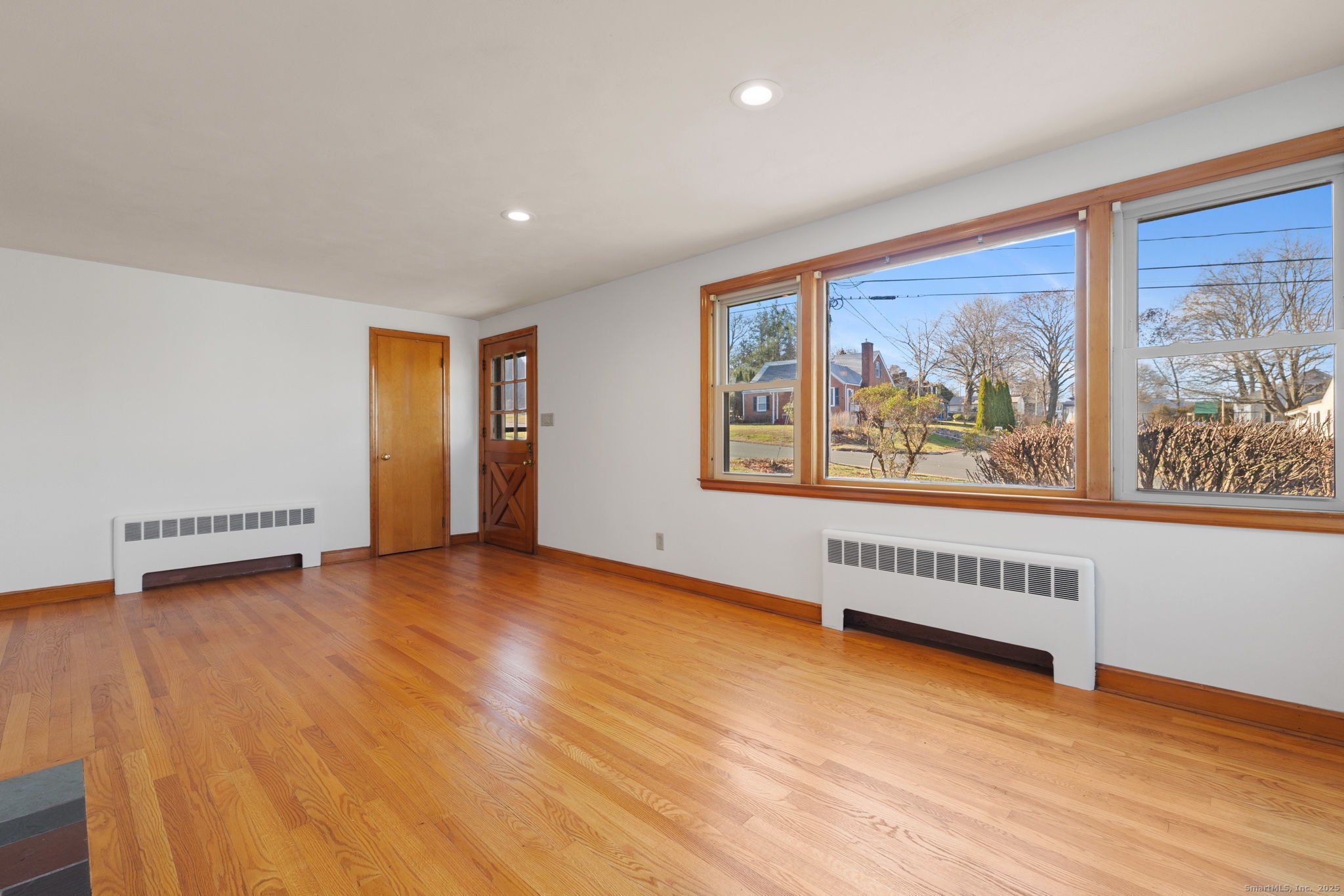 95 Tuttle Street Bristol, CT 06010 - Photo 5 of 28 a view of an empty room with a window and wooden floor