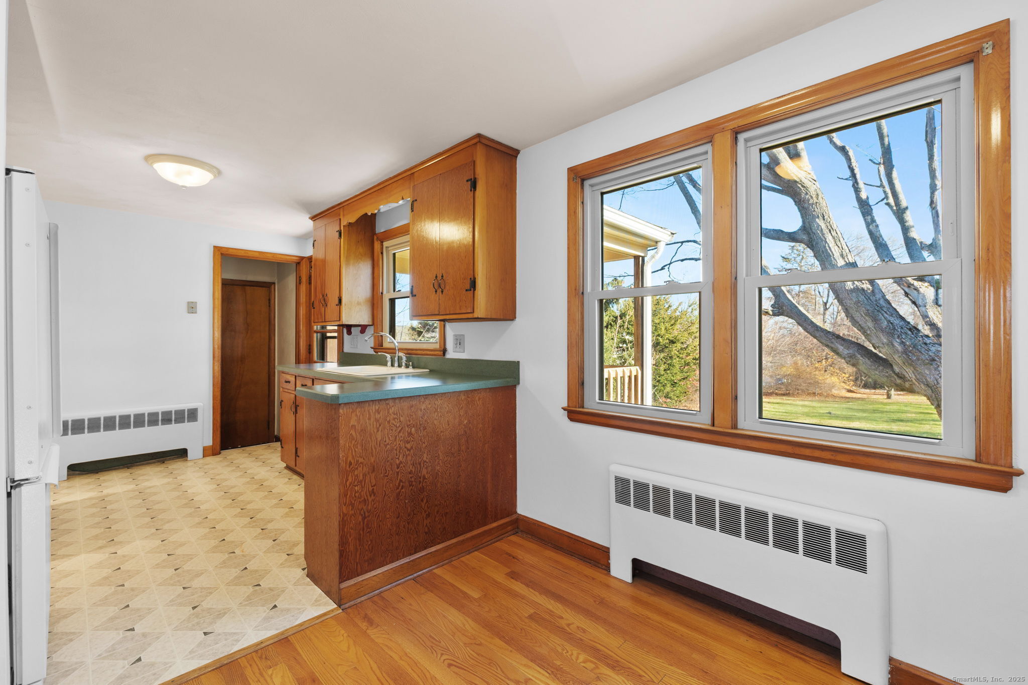 95 Tuttle Street Bristol, CT 06010 - Photo 10 of 28 a view of kitchen with wooden floor and large window