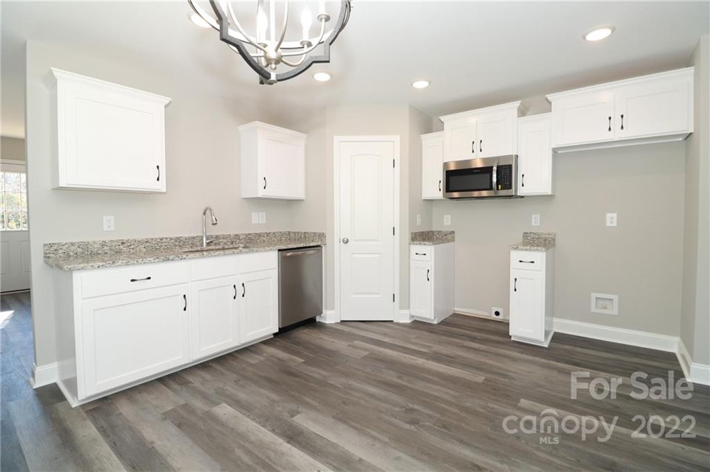 287 Sunderland Road Southwest Concord, NC 28027 - Photo 7 of 16 a kitchen with stainless steel appliances granite countertop a stove a sink and a refrigerator