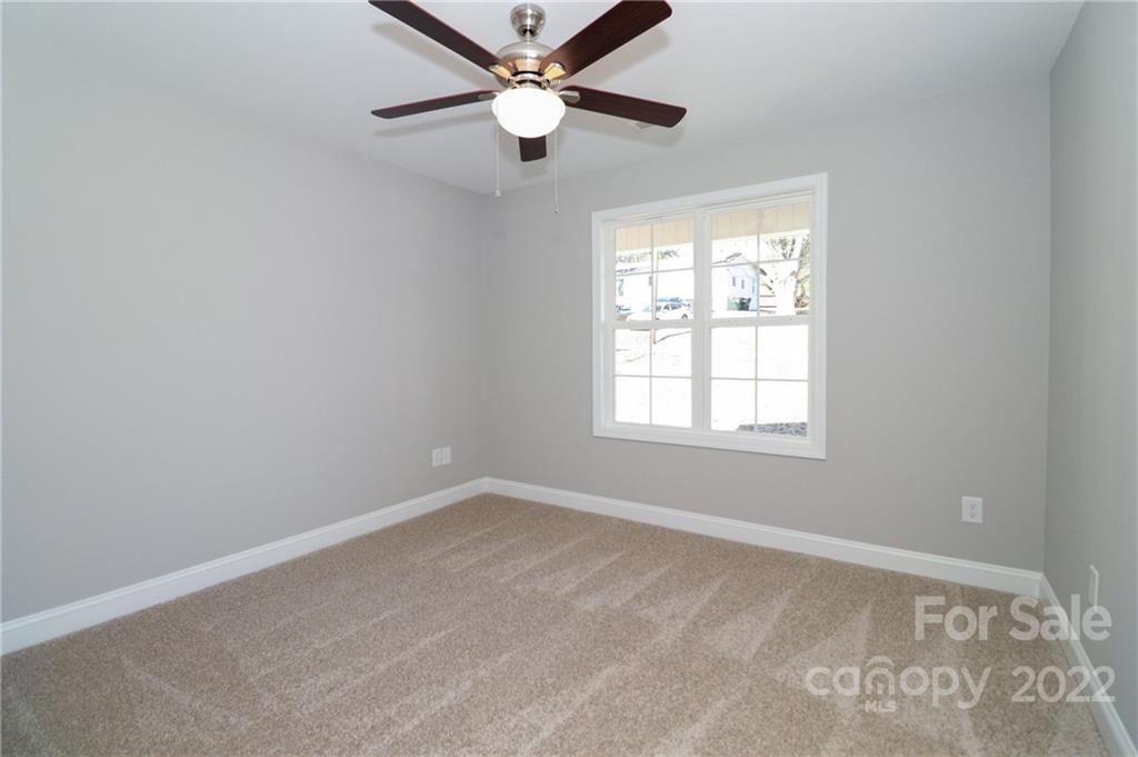 287 Sunderland Road Southwest Concord, NC 28027 - Photo 8 of 16 an empty room with a window and a fan