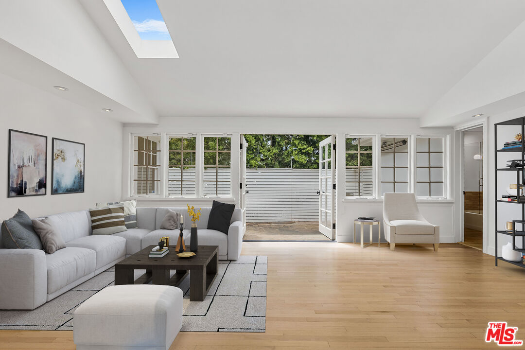 1462 Rising Glen Road Los Angeles, CA 90069 - Photo 15 of 40 a living room with furniture and a large window