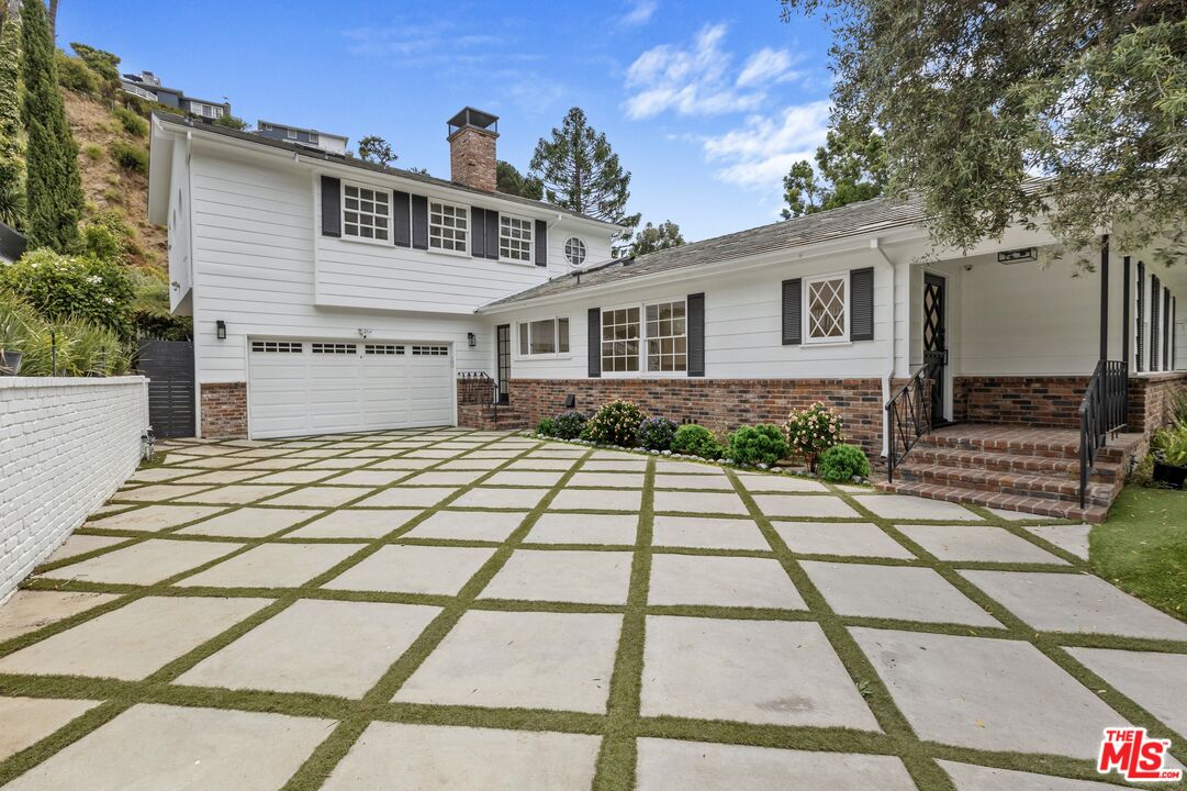 1462 Rising Glen Road Los Angeles, CA 90069 - Photo 2 of 40 a front view of a house with a yard