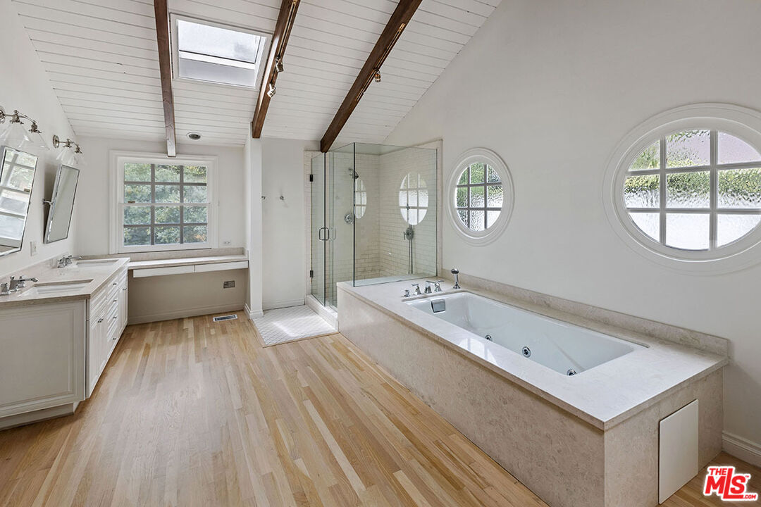 1462 Rising Glen Road Los Angeles, CA 90069 - Photo 31 of 40 a bathroom with a tub sink and mirror