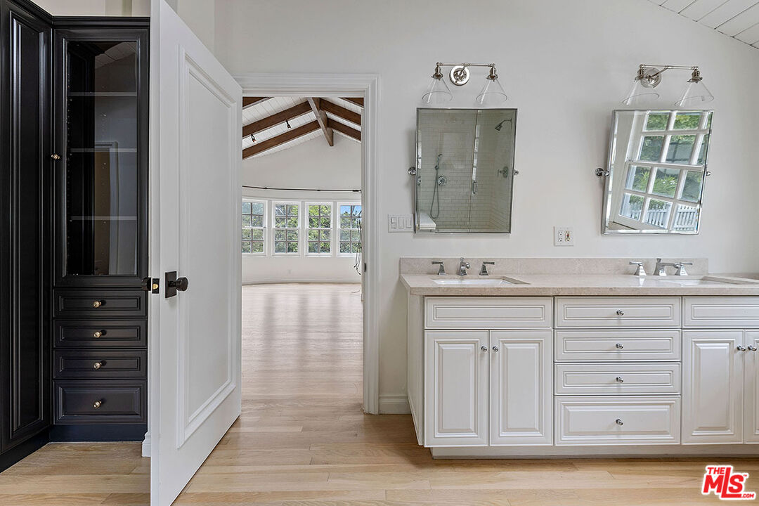 1462 Rising Glen Road Los Angeles, CA 90069 - Photo 32 of 40 a bathroom with a sink and a mirror