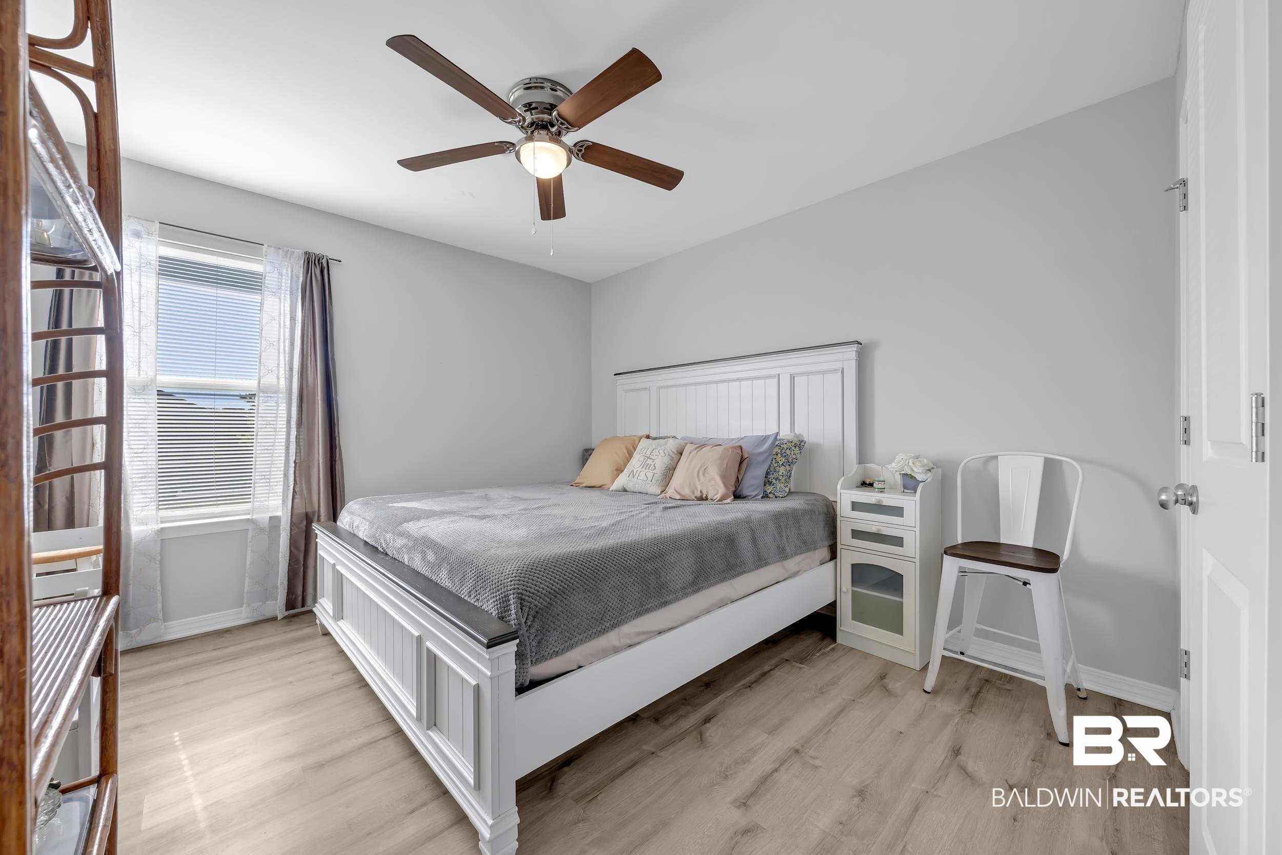 1228 Caper Avenue Foley, AL 36535 - Photo 22 of 54 Spacious room featuring wood-finish flooring, a ceiling fan with light fixture, and light gray wall tones