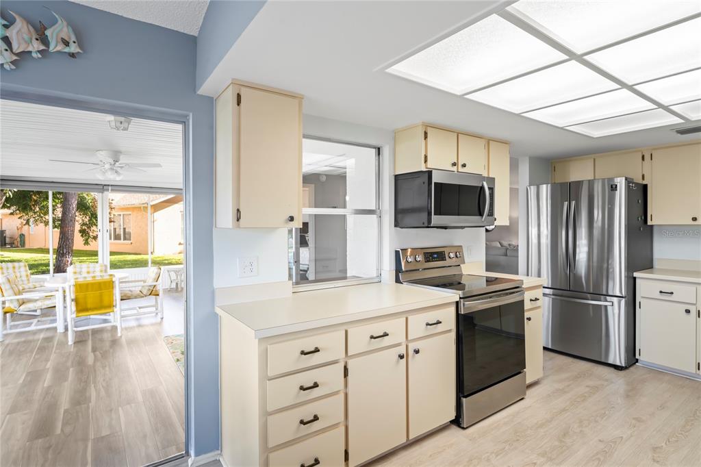 7107 Pond View Court Spring Hill, FL 34606 - Photo 17 of 100 a kitchen with a sink cabinets and stainless steel appliances