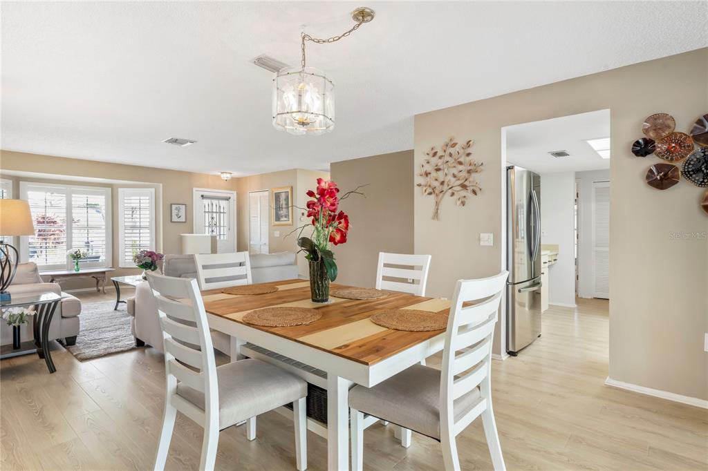 7107 Pond View Court Spring Hill, FL 34606 - Photo 23 of 100 a view of a dining room with furniture and wooden floor