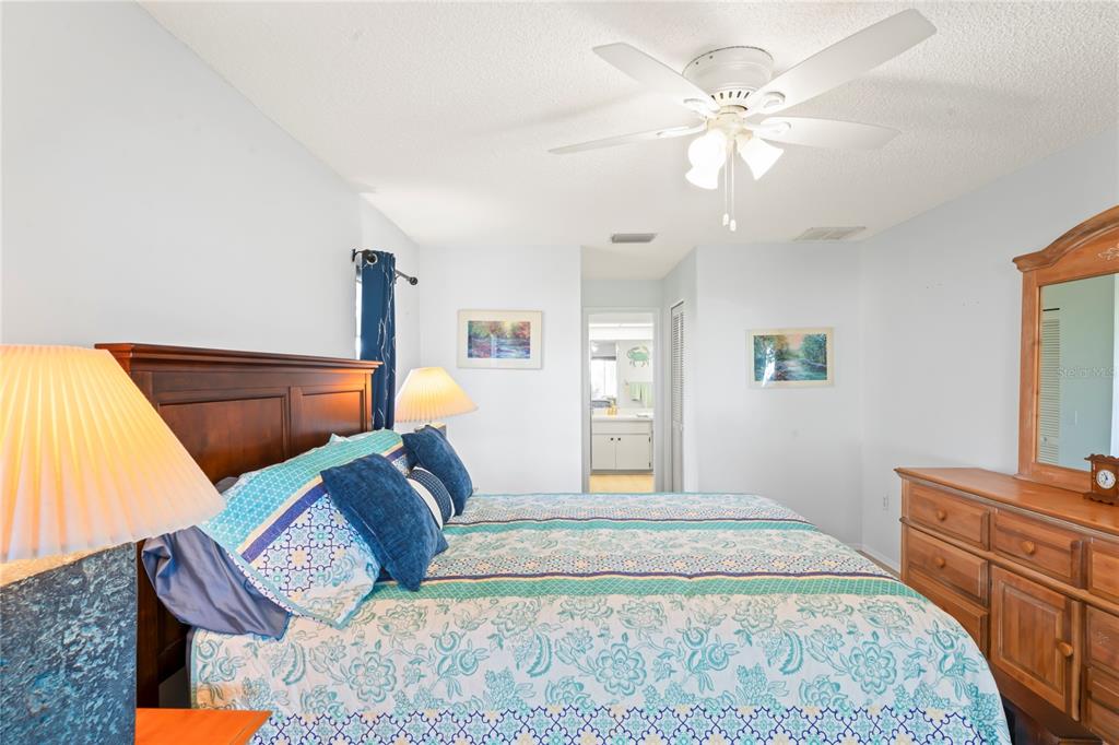 7107 Pond View Court Spring Hill, FL 34606 - Photo 29 of 100 a bedroom with a bed and wooden floor