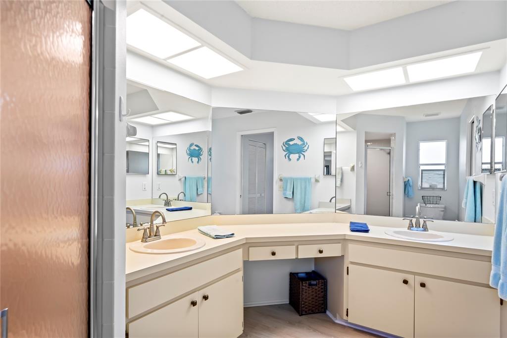 7107 Pond View Court Spring Hill, FL 34606 - Photo 34 of 100 a bathroom with a sink double vanity and a mirror