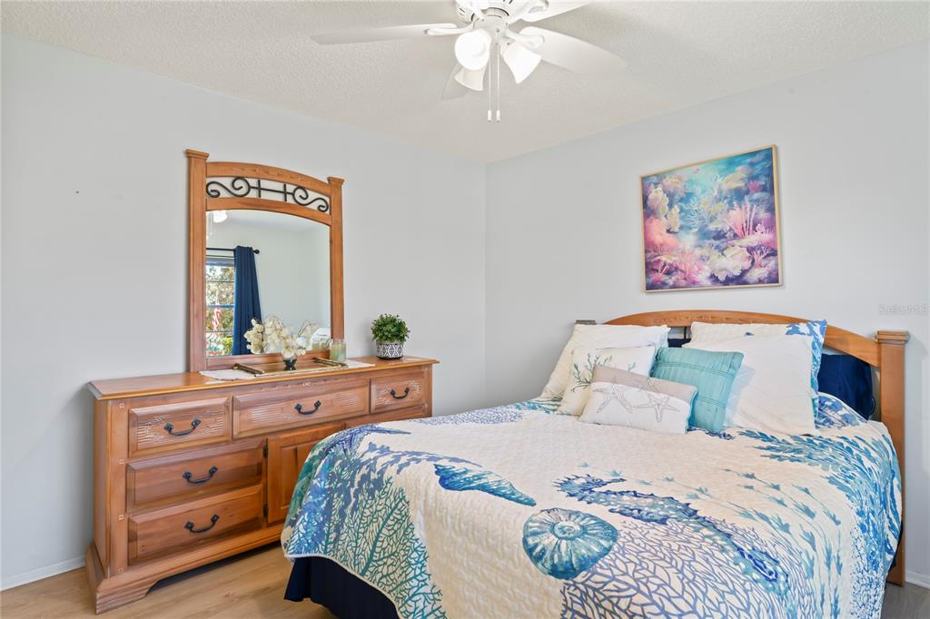 7107 Pond View Court Spring Hill, FL 34606 - Photo 37 of 100 a bedroom with a bed and a dresser in it