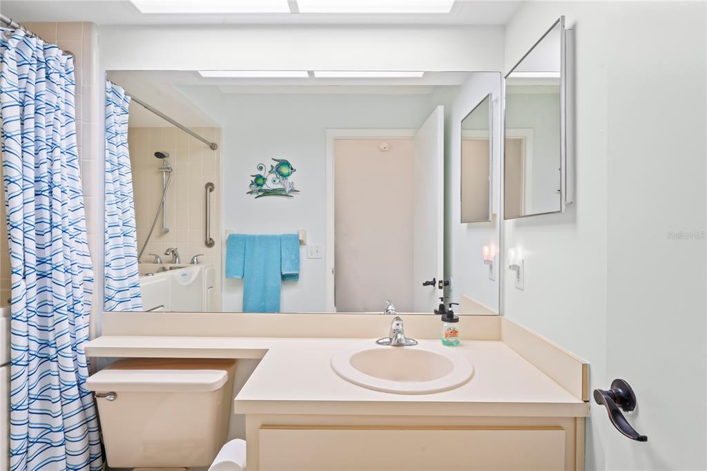 7107 Pond View Court Spring Hill, FL 34606 - Photo 40 of 100 a bathroom with a toilet a sink and a mirror