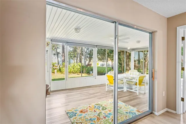 an aerial view of a swimming pool with a yard and lake view