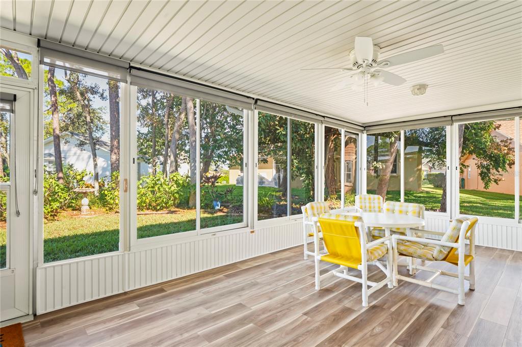 7107 Pond View Court Spring Hill, FL 34606 - Photo 47 of 100 a view of a dining room with furniture wooden floor and garden view
