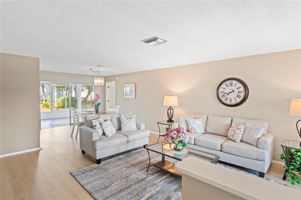 7107 Pond View Court Spring Hill, FL 34606 - Photo 7 of 100 a living room with furniture and a large window