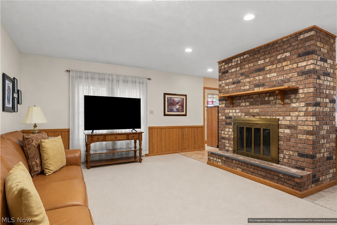 1835 Lynn Road Kent, OH 44240 - Photo 7 of 48 Spacious interior featuring a prominent brick fireplace with a brass-trimmed insert, wood mantel, and raised hearth