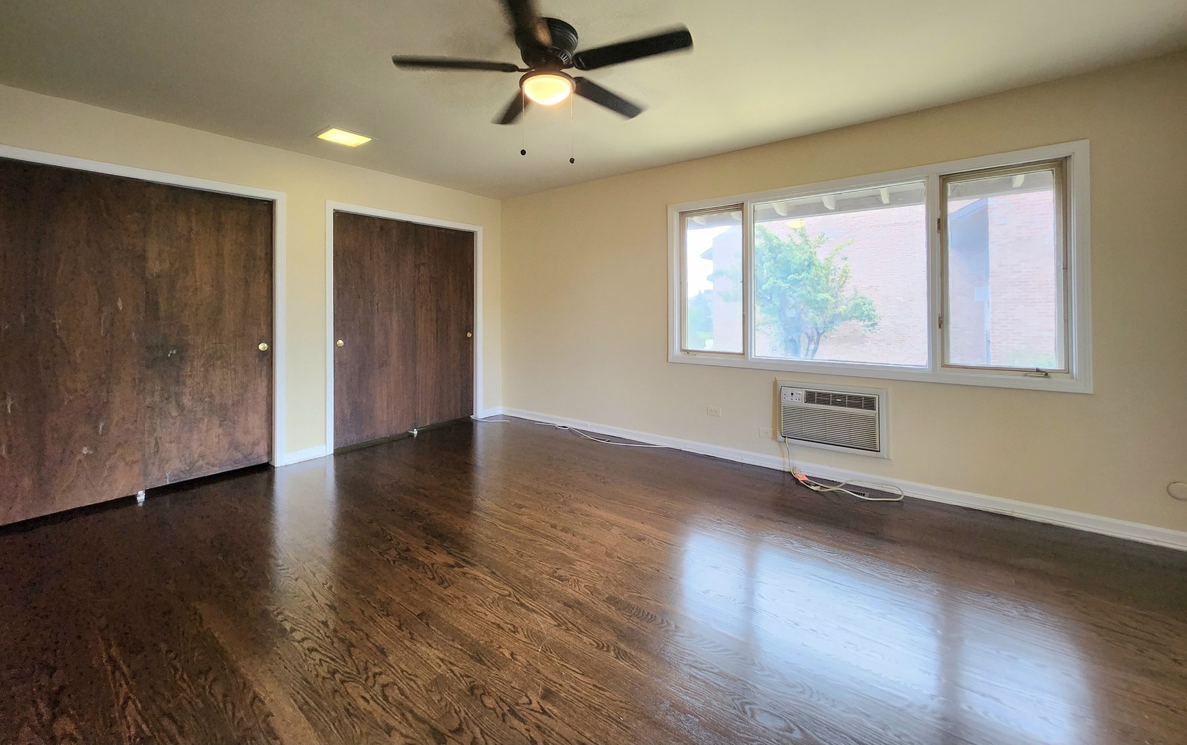 818 Concord Lane, Unit 818 Barrington, IL 60010 - Photo 11 of 16 a view of an empty room with wooden floor and a window