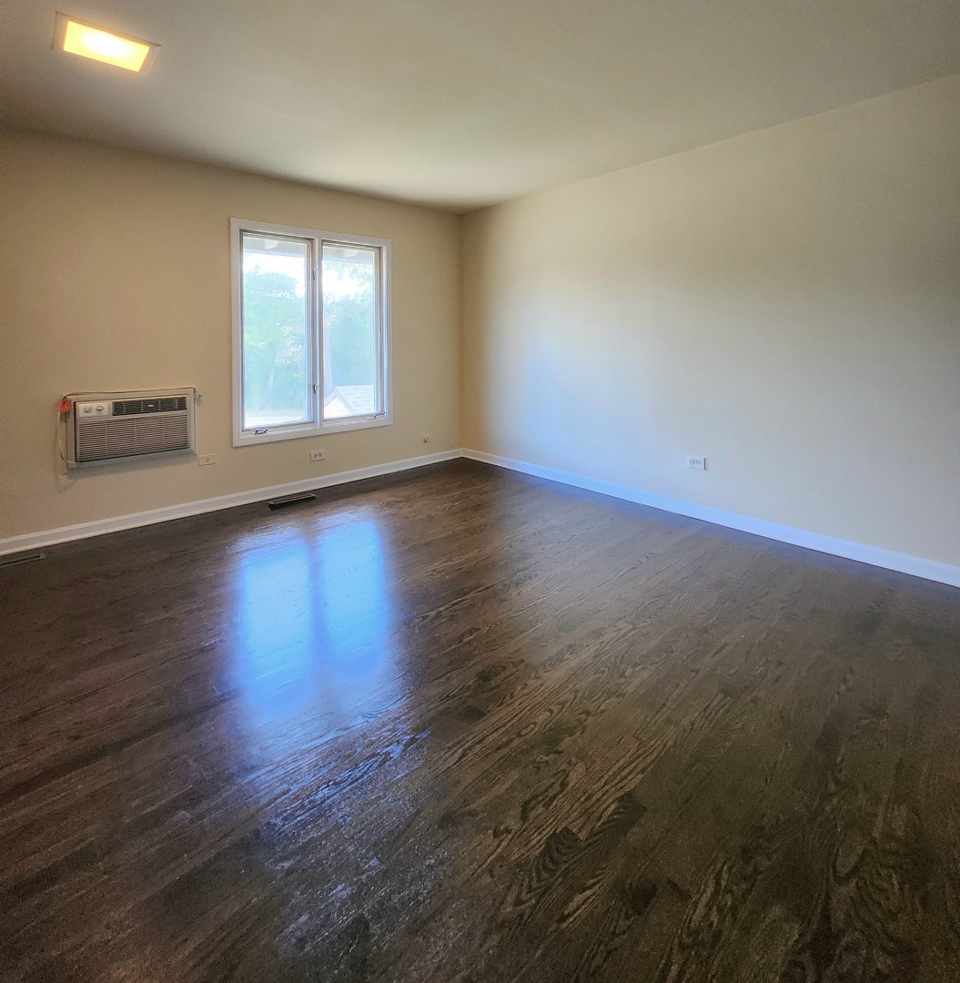 818 Concord Lane, Unit 818 Barrington, IL 60010 - Photo 13 of 16 an empty room with wooden floor and windows