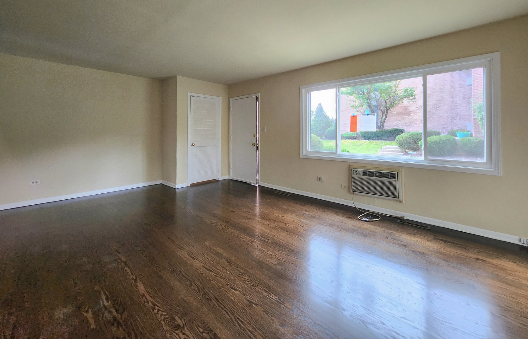 818 Concord Lane, Unit 818 Barrington, IL 60010 - Photo 8 of 16 an empty room with wooden floor and windows